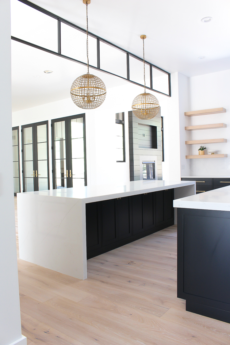 Black steel transom modern kitchen with black cabinets double islands