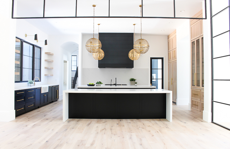 Modern Kitchen with double islands black and rift sawn white oak cabinets open shelves steel transoms