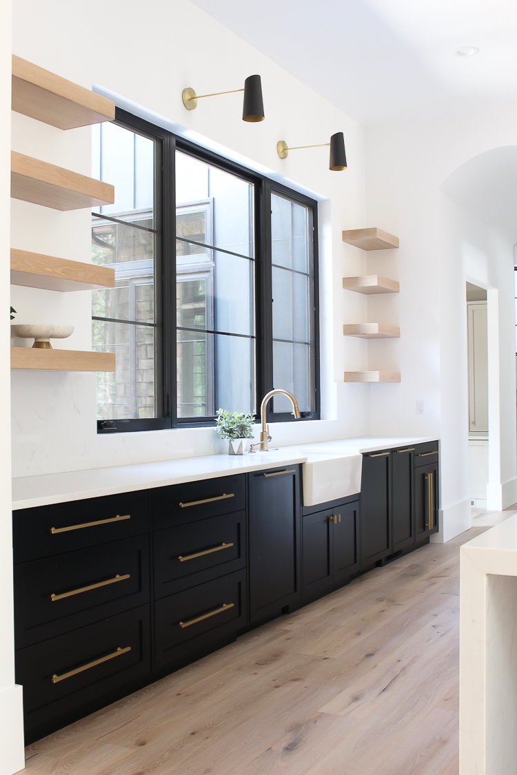 floating white oak kitchen shelves with black lower cabinets