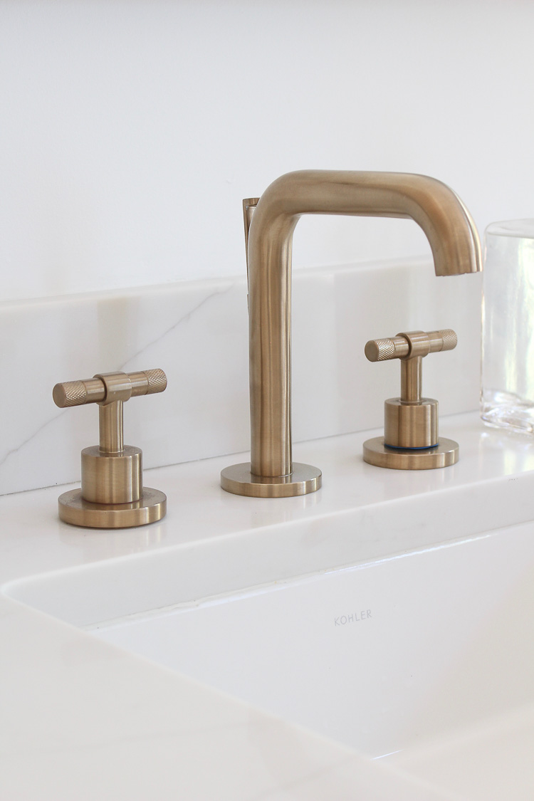 Modern Vintage Master bathroom with white oak cabinets, marble tile, and brass fixtures