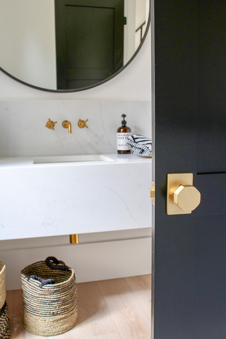 Modern Bathroom with black doors and gold hardware