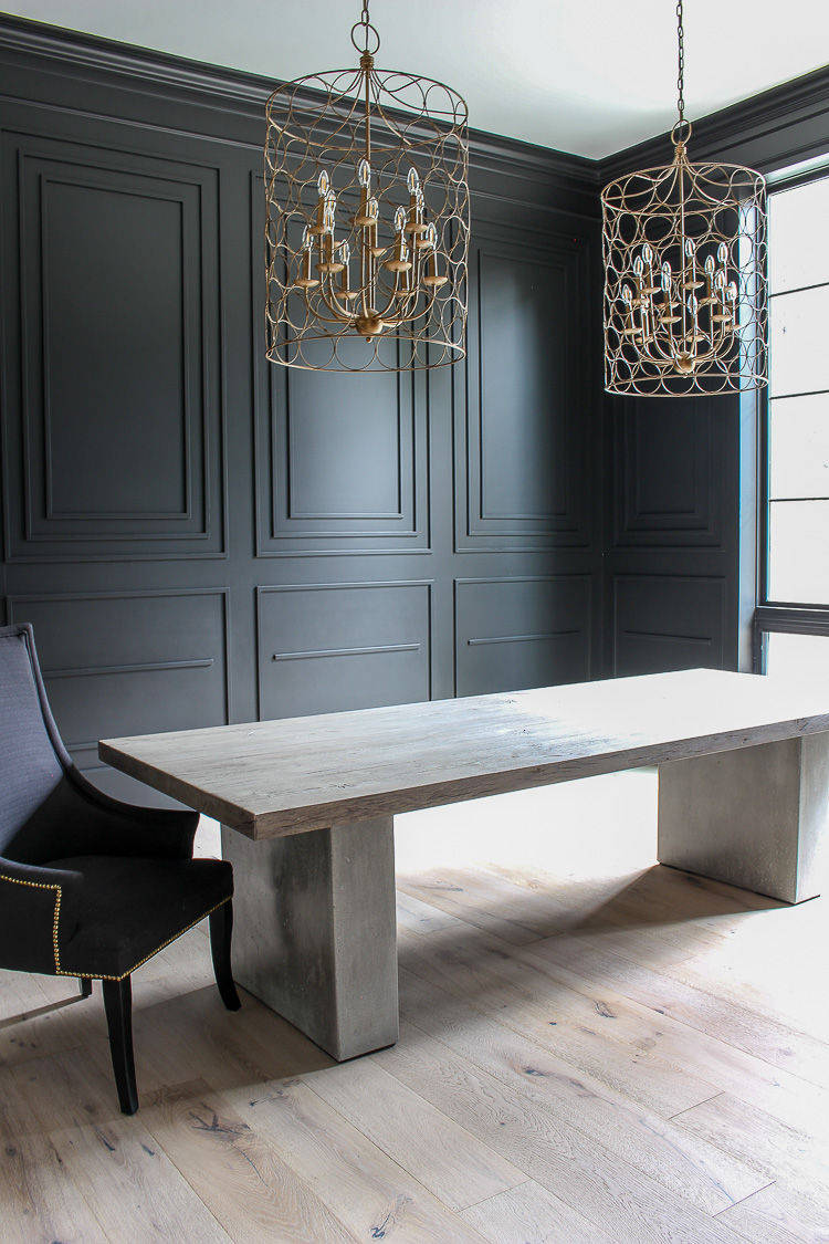 black millwork dramatic dining room concrete table modern