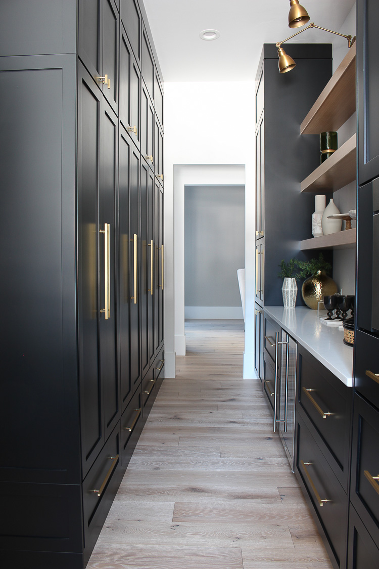 butler's-pantry-black-cabinets-white-oak-floating-shelves-gold-hardware-marble-quartz