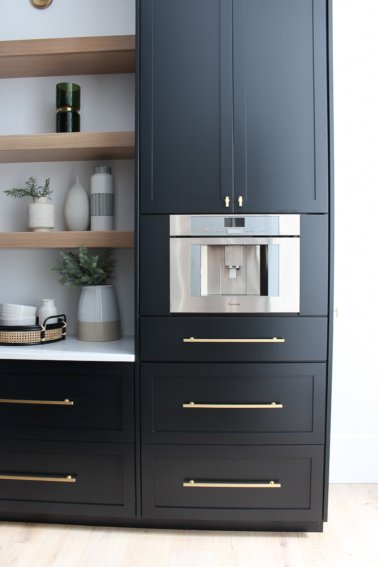 https://thehouseofsilverlining.com/wp-content/uploads/2018/11/butlers-pantry-black-cabinets-white-oak-floating-shelves-gold-hardware-marble-quartz-4.jpg