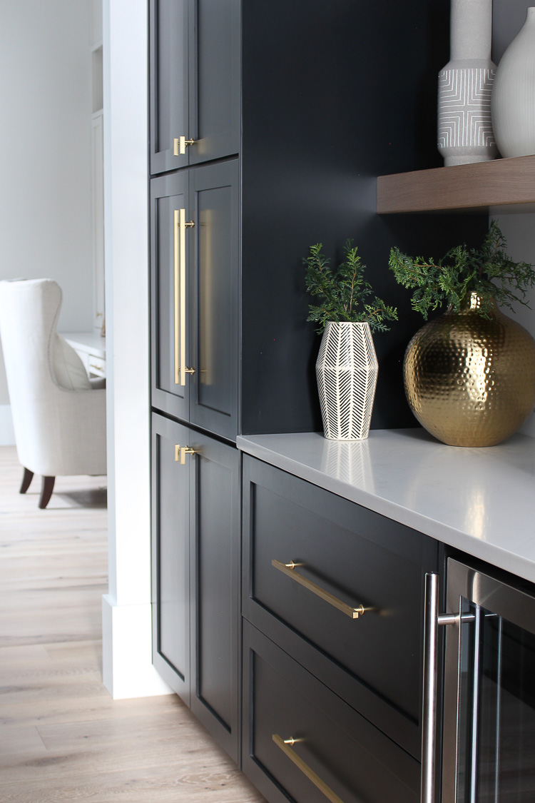 butler's-pantry-black-cabinets-white-oak-floating-shelves-gold-hardware-marble-quartz
