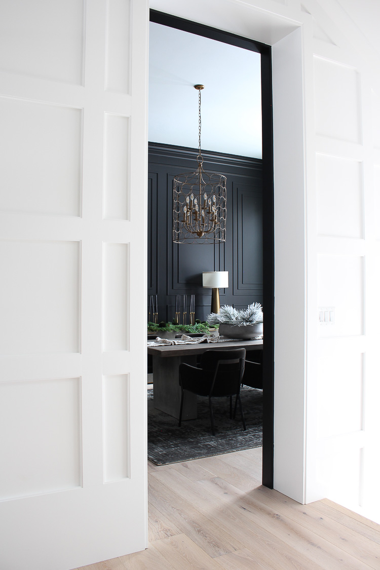 moody black dining room with modern crown mouldings christmas style