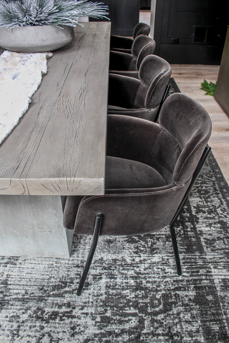 dramatic modern black dining room with aged oak and concrete table velvet dining chairs