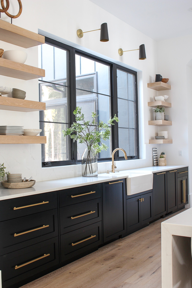 floating white oak shelves with black cabinets kitchen