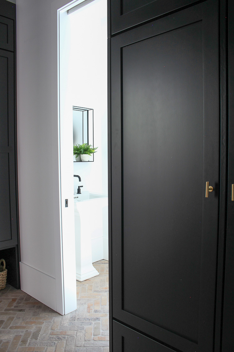 mudroom-brick-herringbone-floor-black-shiplap-walls-black-cabinets