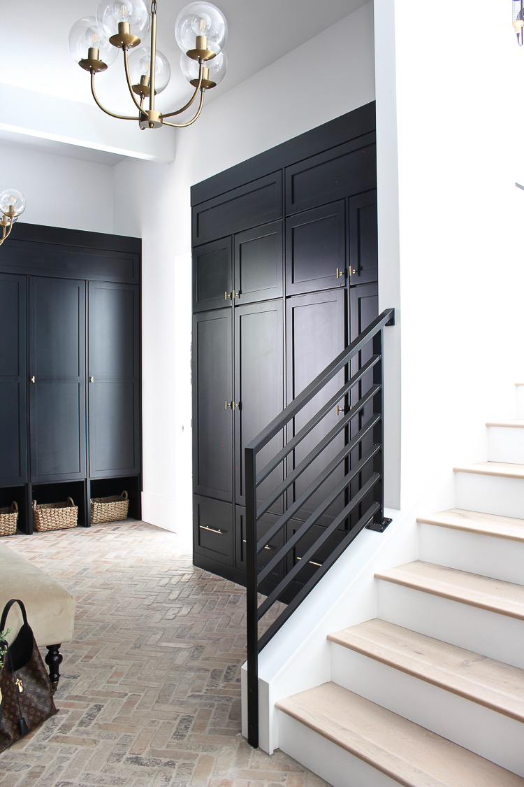 https://thehouseofsilverlining.com/wp-content/uploads/2019/06/mudroom-brick-herringbone-floor-black-shiplap-walls-black-cabinets-4.jpg