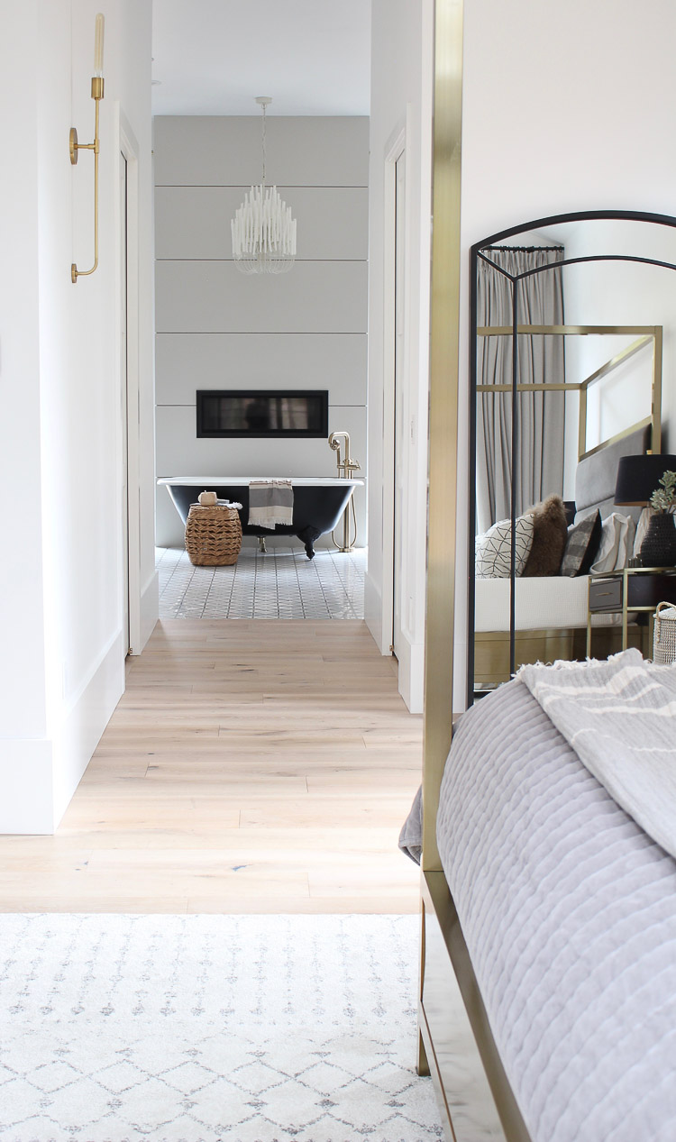 transitional-modern-master-bedroom-brass-canopy-bed-large-windows